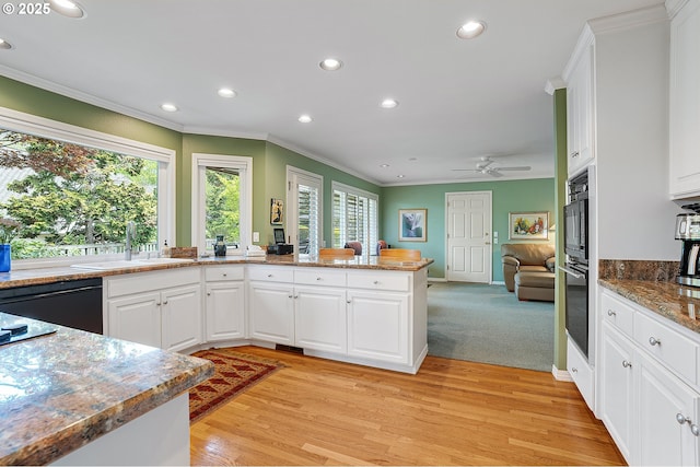 kitchen with crown molding, a sink, recessed lighting, white cabinetry, and a ceiling fan