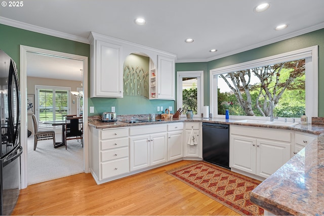 kitchen with black appliances, a sink, crown molding, light wood finished floors, and recessed lighting