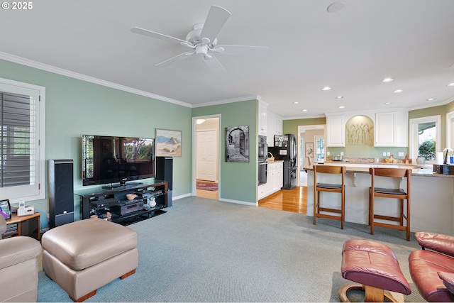 living room featuring crown molding, light carpet, recessed lighting, ceiling fan, and baseboards