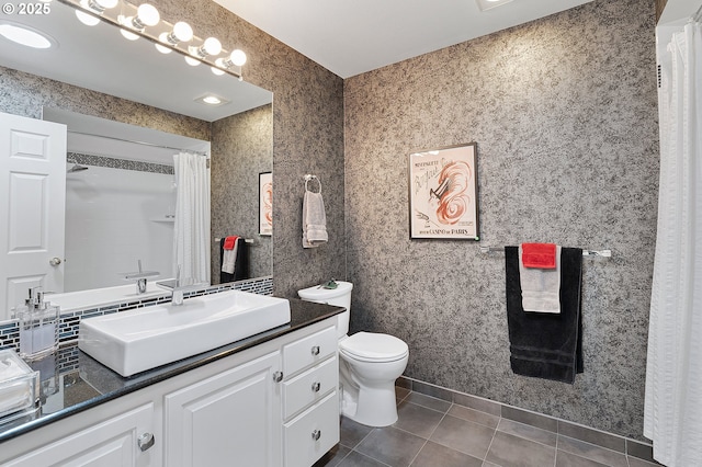 bathroom featuring tile patterned flooring, toilet, vanity, and curtained shower