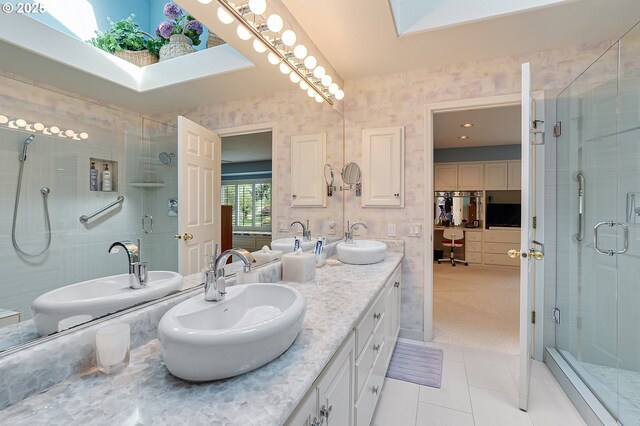 full bath featuring a stall shower, tile patterned flooring, and double vanity