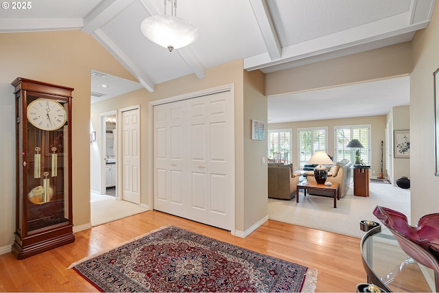 entryway with light wood-type flooring and baseboards