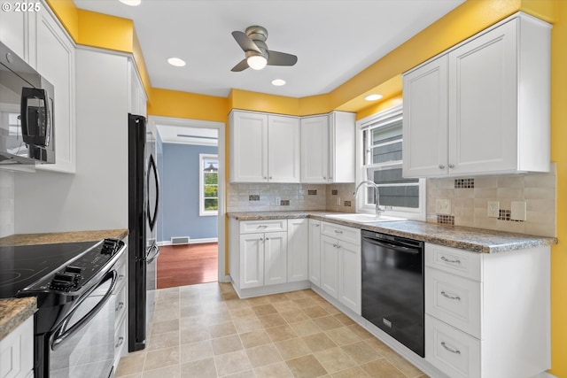 4621 NE 37th Ave, Portland, OR 97211 - kitchen with black appliances, a sink, a ceiling fan, white cabinets, and decorative backsplash