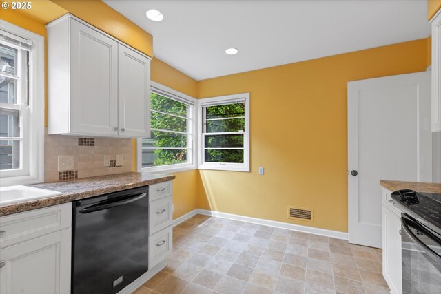 4621 NE 37th Ave, Portland, OR 97211 - kitchen featuring black dishwasher, baseboards, stove, and white cabinets