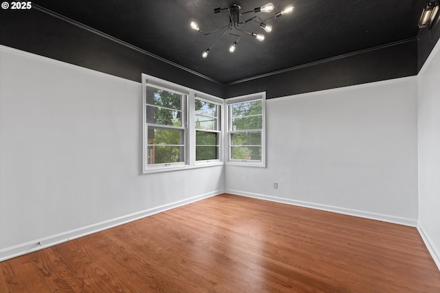 4621 NE 37th Ave, Portland, OR 97211 - empty room with wood finished floors, a chandelier, and baseboards