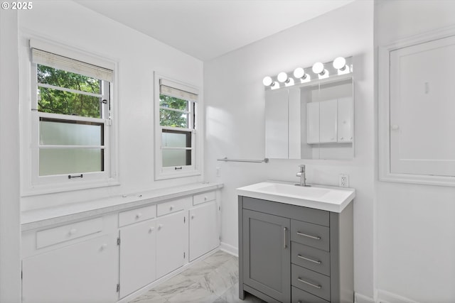 4621 NE 37th Ave, Portland, OR 97211 - bathroom with marble look tile flooring, vanity, and baseboards