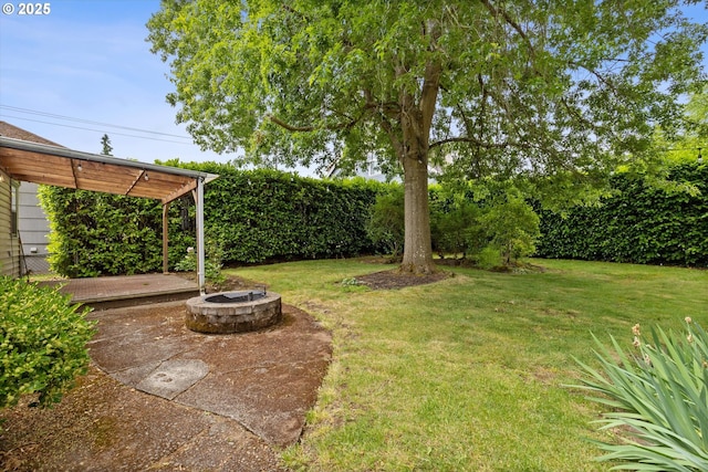 4621 NE 37th Ave, Portland, OR 97211 - view of grassy yard featuring an outdoor fire pit and a patio area
