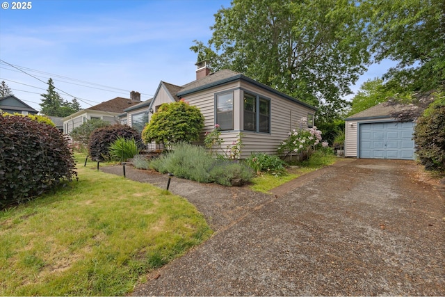 4621 NE 37th Ave, Portland, OR 97211 - view of front of house featuring driveway, an outbuilding, a garage, and a front yard