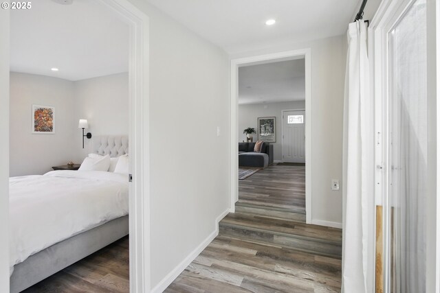 bedroom featuring wood finished floors, recessed lighting, and baseboards