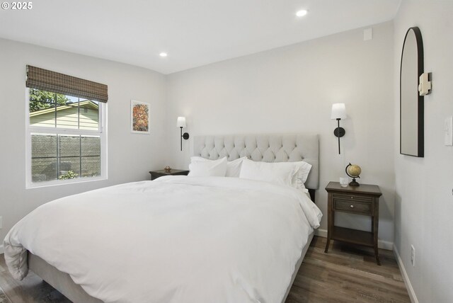 bedroom with wood finished floors, recessed lighting, and baseboards
