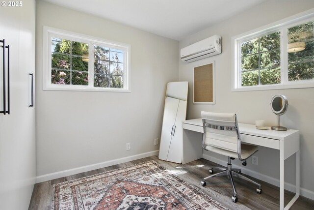office area with a wall mounted AC, healthy amount of natural light, and wood finished floors