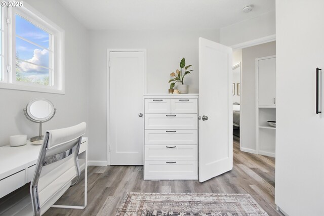 office space with light wood-style floors and baseboards