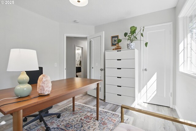 office space featuring light wood-style floors and baseboards