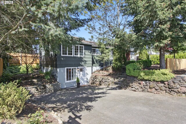 view of front facade with a patio and fence