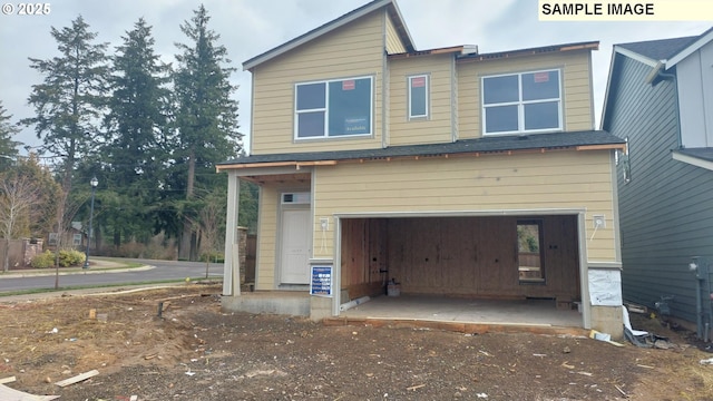 rear view of house with a garage