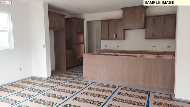 kitchen featuring dark brown cabinets and light tile patterned flooring