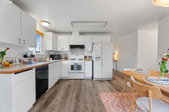 13816 NE 85th St, Vancouver, WA 98682 - kitchen featuring black appliances, under cabinet range hood, light countertops, light wood finished floors, and white cabinetry