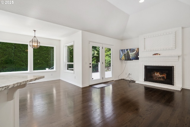 12723 Adrian Ct, Lake Oswego, OR 97034 - unfurnished living room featuring dark wood-type flooring, a fireplace, and vaulted ceiling