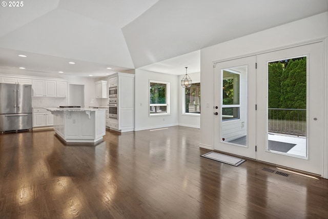 12723 Adrian Ct, Lake Oswego, OR 97034 - unfurnished living room featuring healthy amount of natural light, dark wood-style floors, recessed lighting, and high vaulted ceiling