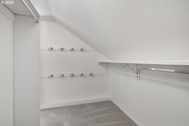 12723 Adrian Ct, Lake Oswego, OR 97034 - spacious closet with carpet flooring and vaulted ceiling