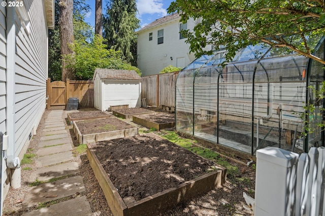 12723 Adrian Ct, Lake Oswego, OR 97034 - fenced backyard with an exterior structure, a vegetable garden, and an outdoor structure