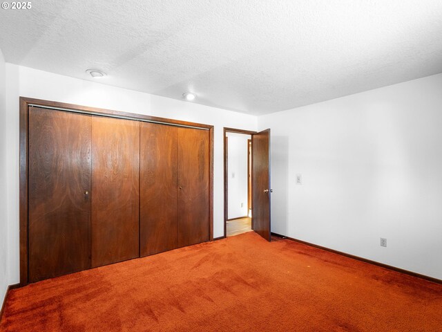 15416 NE Holladay St, Portland, OR 97230 - unfurnished bedroom featuring baseboards, a closet, carpet flooring, and a textured ceiling