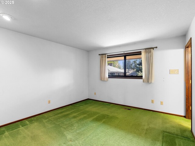 15416 NE Holladay St, Portland, OR 97230 - carpeted empty room with visible vents, a textured ceiling, and baseboards