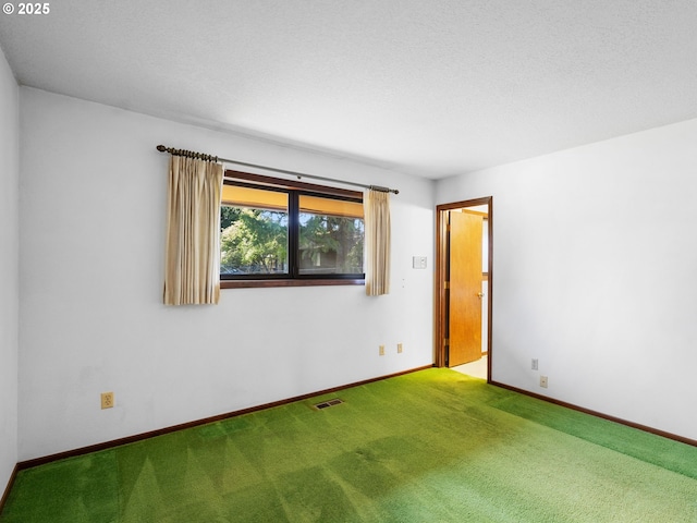 15416 NE Holladay St, Portland, OR 97230 - carpeted empty room with visible vents, a textured ceiling, and baseboards