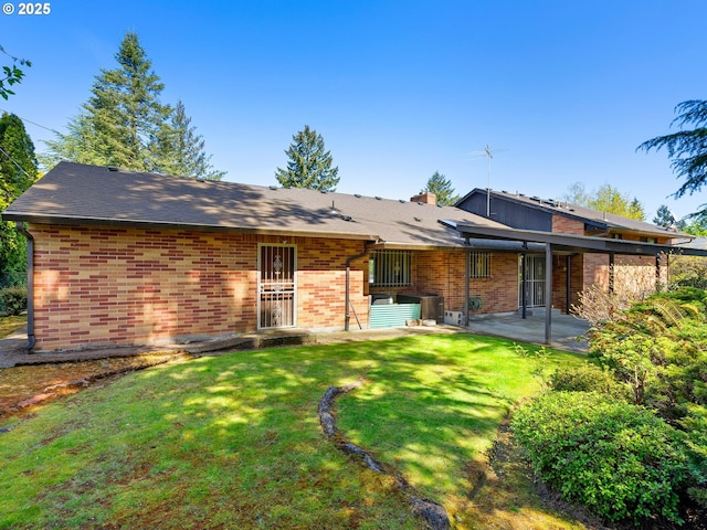 15416 NE Holladay St, Portland, OR 97230 - rear view of property featuring a lawn, a patio area, and brick siding
