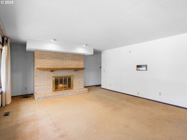 15416 NE Holladay St, Portland, OR 97230 - unfurnished living room featuring visible vents, carpet floors, a brick fireplace, baseboards, and a textured ceiling