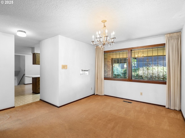 15416 NE Holladay St, Portland, OR 97230 - unfurnished room featuring a textured ceiling, visible vents, baseboards, an inviting chandelier, and carpet flooring