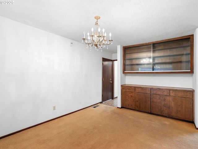 15416 NE Holladay St, Portland, OR 97230 - unfurnished dining area with an inviting chandelier, baseboards, and carpet