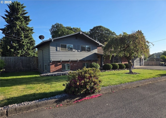 447 Cc St, Woodland, WA 98674 - view of front of home with asphalt driveway, a garage, and brick siding