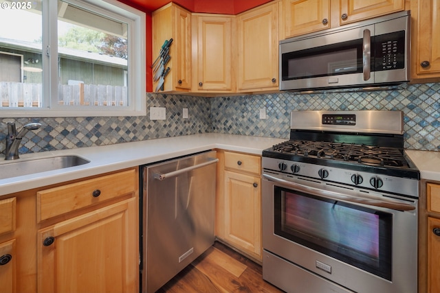 1378 SW Taylors Ferry Ct, Portland, OR 97219 - kitchen featuring stainless steel appliances, light countertops, backsplash, and wood finished floors