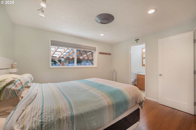 1378 SW Taylors Ferry Ct, Portland, OR 97219 - bedroom featuring wood finished floors, recessed lighting, a textured ceiling, and ensuite bath