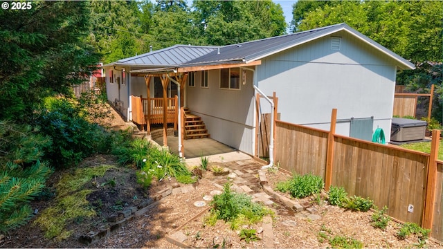 1378 SW Taylors Ferry Ct, Portland, OR 97219 - back of house featuring a metal roof, a deck, and a patio