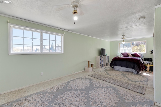 bedroom with ceiling fan, baseboards, and a textured ceiling