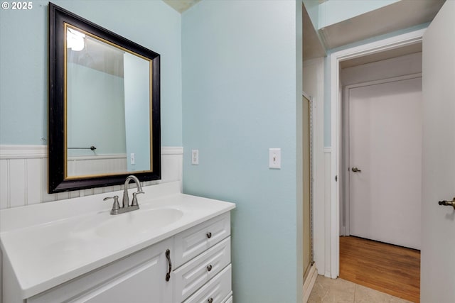 bathroom featuring a stall shower, tile patterned flooring, and vanity