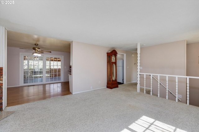 spare room featuring ceiling fan, carpet floors, and baseboards