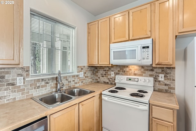 kitchen featuring a sink, decorative backsplash, light brown cabinets, and white appliances