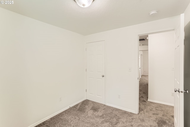 unfurnished bedroom with baseboards and light colored carpet
