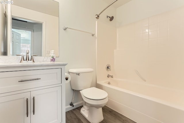 full bath with vanity, toilet, baseboards, tub / shower combination, and wood finished floors