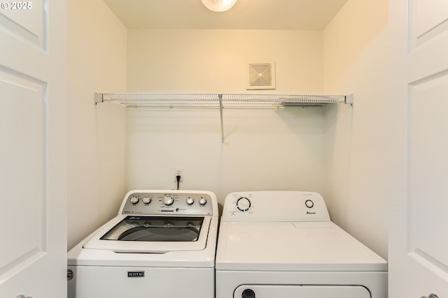 washroom with laundry area, independent washer and dryer, and visible vents