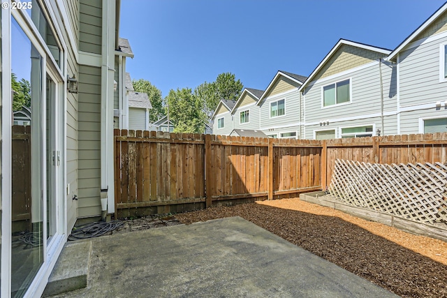 view of yard with a fenced backyard, a patio area, and a residential view