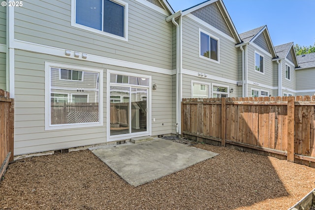 back of property with a patio area and fence
