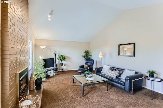 living room with lofted ceiling, carpet floors, a brick fireplace, and baseboards