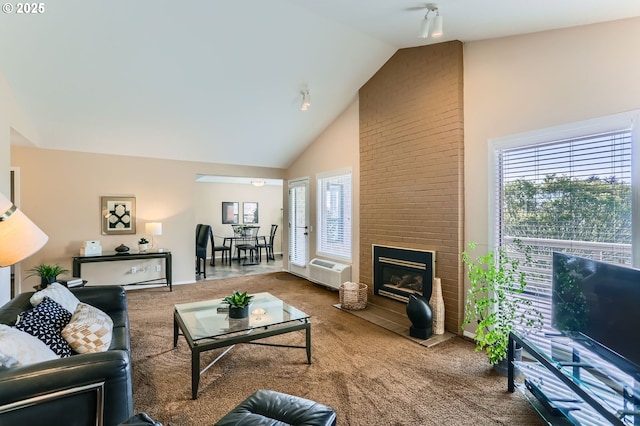 carpeted living area featuring high vaulted ceiling, a fireplace, and a wall unit AC