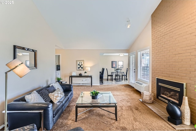 carpeted living room featuring high vaulted ceiling, a wall mounted AC, and a brick fireplace