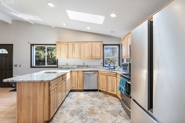 169 W 2nd St, Lafayette, OR 97127 - kitchen with light brown cabinets, dishwasher, lofted ceiling, a skylight, and a peninsula
