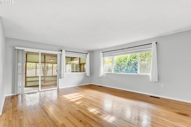 spare room with hardwood / wood-style flooring